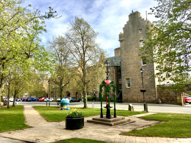 Dunrobin Castle with a bird of prey in flight in the Scottish Highlands