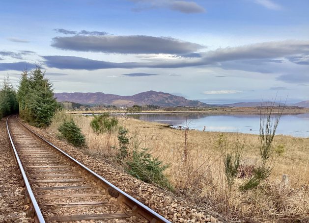Railway line with view west towards Struie Hill in the Scottish Highlands